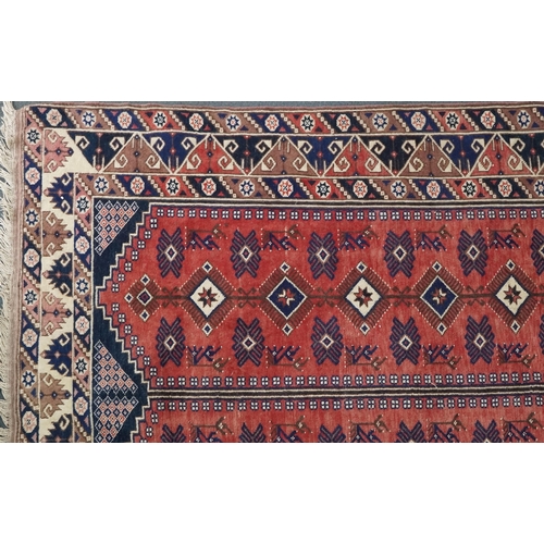 1016 - A Turkish Oushak carpet, mid 20th century, the blue field with two central columns with stylized mot... 