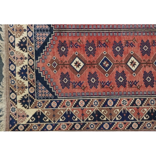 1016 - A Turkish Oushak carpet, mid 20th century, the blue field with two central columns with stylized mot... 