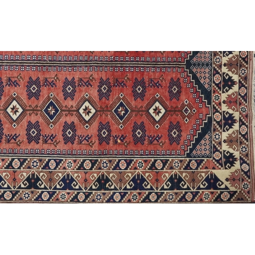 1016 - A Turkish Oushak carpet, mid 20th century, the blue field with two central columns with stylized mot... 