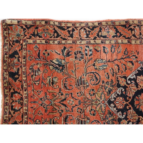 1039 - A Sarouk rug, North West Persia, mid 20th century, the charcoal field with a central stylized medall... 