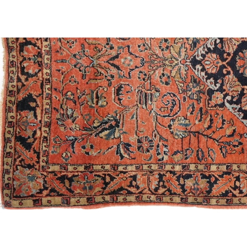 1039 - A Sarouk rug, North West Persia, mid 20th century, the charcoal field with a central stylized medall... 