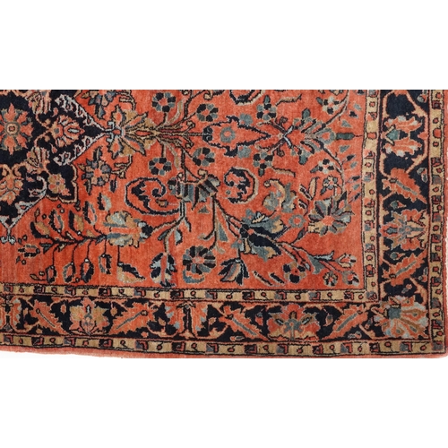 1039 - A Sarouk rug, North West Persia, mid 20th century, the charcoal field with a central stylized medall... 