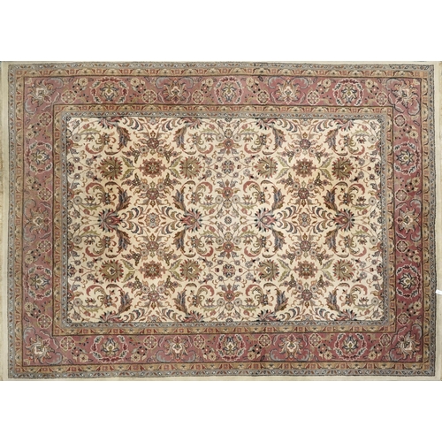 A Nain carpet, North West Persia, late 20th century, the ivory field with stylized flowers within a complementary border, 245cm x 175cm