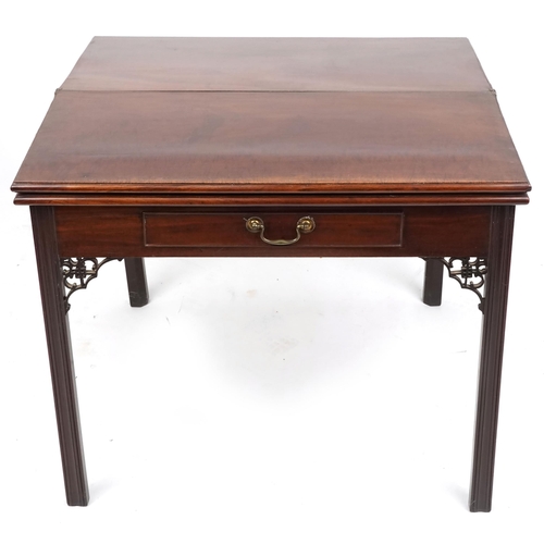  A George III mahogany fold-over tea/card table fitted with a single frieze drawer, raised on moulded... 