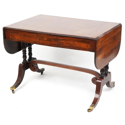 1073 - An early 19th century mahogany sofa table fitted with two frieze drawers raised on sabre legs, 70cm ... 