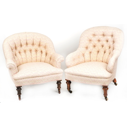 1008 - Two similar Victorian tub back armchairs raised on turned legs and castors,  87cm high x 69cm wide.