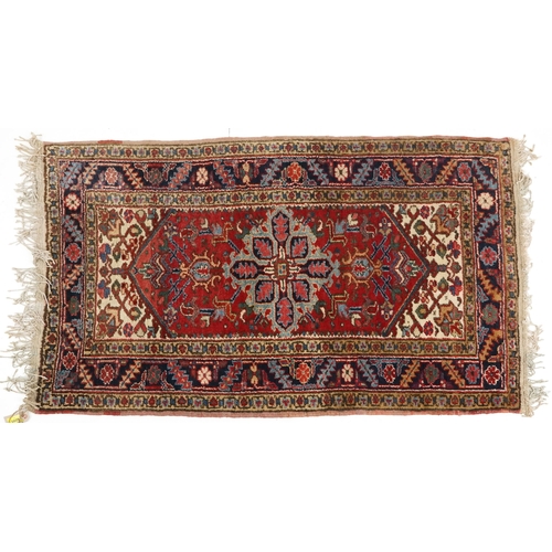 1072 - A Turkish Heriz rug, mid 20th century, the blue field with a central stylized medallion within a com... 