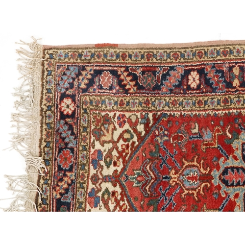 1072 - A Turkish Heriz rug, mid 20th century, the blue field with a central stylized medallion within a com... 