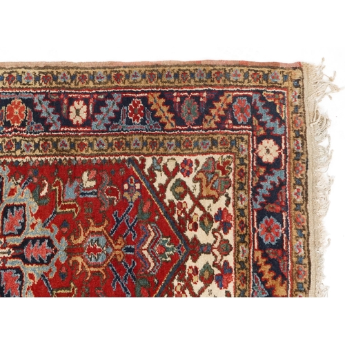 1072 - A Turkish Heriz rug, mid 20th century, the blue field with a central stylized medallion within a com... 