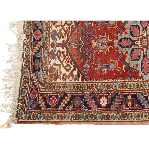 1072 - A Turkish Heriz rug, mid 20th century, the blue field with a central stylized medallion within a com... 