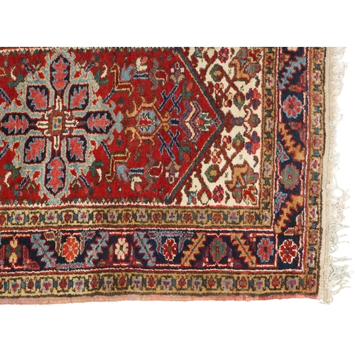 1072 - A Turkish Heriz rug, mid 20th century, the blue field with a central stylized medallion within a com... 