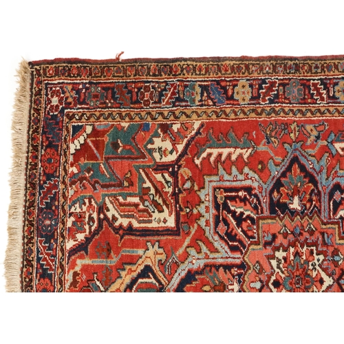 1038 - A Heriz rug, North West Persia, 20th century, the midnight blue field with a central flower head med... 