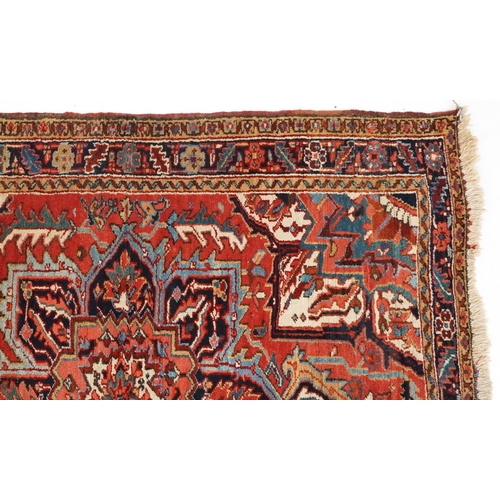 1038 - A Heriz rug, North West Persia, 20th century, the midnight blue field with a central flower head med... 