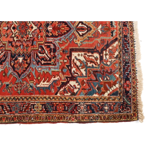 1038 - A Heriz rug, North West Persia, 20th century, the midnight blue field with a central flower head med... 