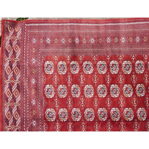  A Pakistan Bokhara carpet, late 20th century, the red field with six central columns of guls within ... 