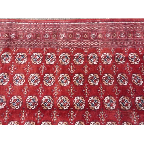  A Pakistan Bokhara carpet, late 20th century, the red field with six central columns of guls within ... 