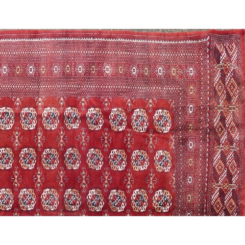  A Pakistan Bokhara carpet, late 20th century, the red field with six central columns of guls within ... 