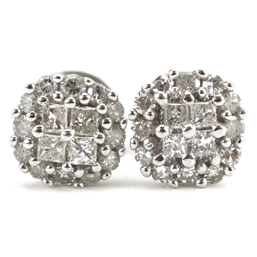 75 - A pair of 9ct white gold diamond cluster stud earrings set with princess cut and round brilliant cut... 