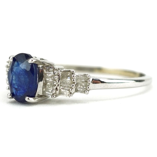  A 9ct white gold sapphire ring with baguette cut diamond stepped shoulders, the sapphire approximate... 