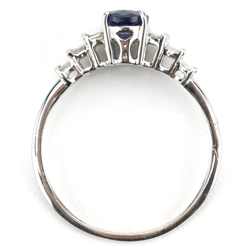  A 9ct white gold sapphire ring with baguette cut diamond stepped shoulders, the sapphire approximate... 