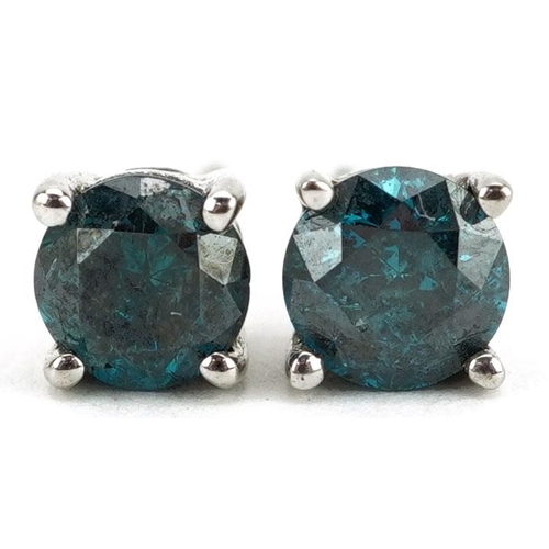 349 - A pair of 9ct white gold blue diamond solitaire stud earrings, total diamond weight approximately 1.... 