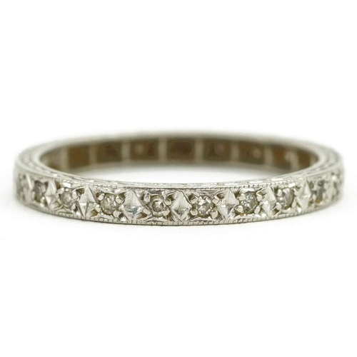 404 - A platinum and diamond eternity ring, size L/M, 2.6g.