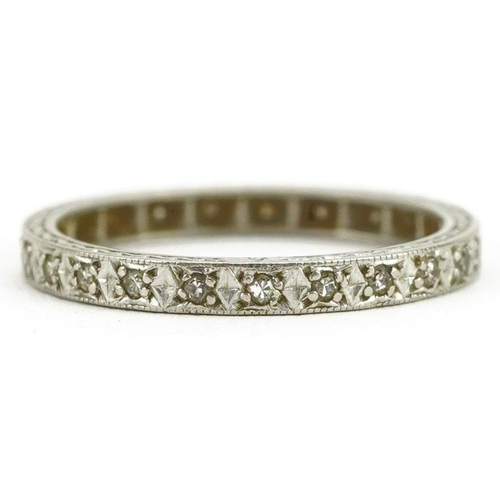 404 - A platinum and diamond eternity ring, size L/M, 2.6g.