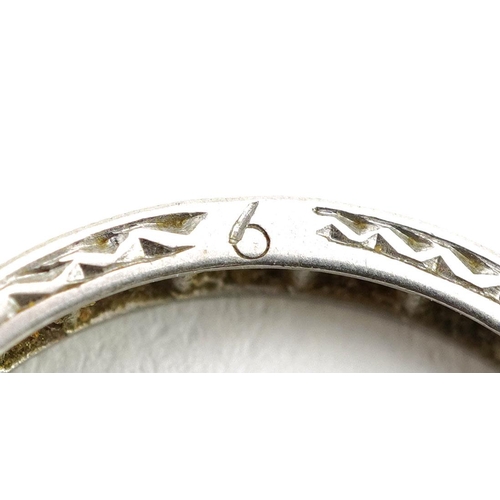 404 - A platinum and diamond eternity ring, size L/M, 2.6g.