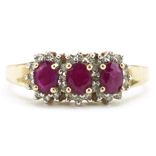 422 - A 9ct gold ruby and diamond triple cluster ring, size P, 2.4g.