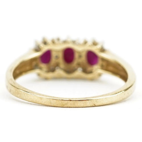 422 - A 9ct gold ruby and diamond triple cluster ring, size P, 2.4g.