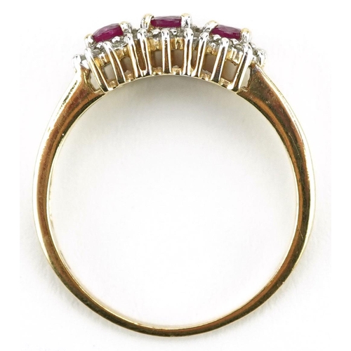 422 - A 9ct gold ruby and diamond triple cluster ring, size P, 2.4g.