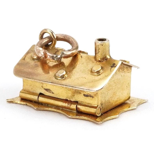 231 - A 9ct gold charm in the form of a cottage opening to reveal figures in a bed, 1.5cm wide, 2.4g.