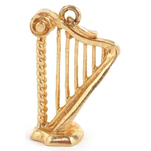 323 - A 9ct gold charm in the form a harp, 2cm high, 2.4g.