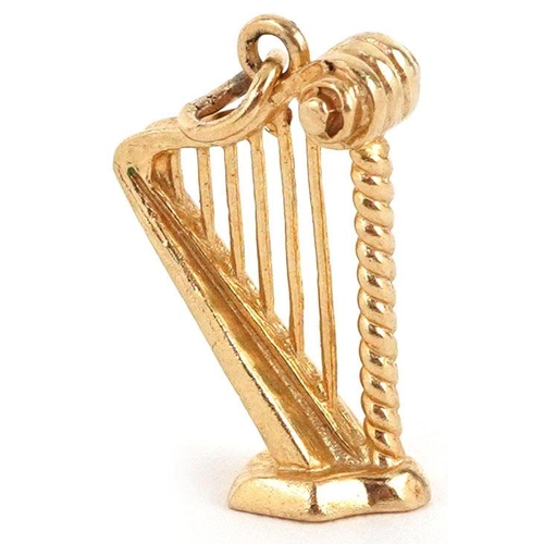 323 - A 9ct gold charm in the form a harp, 2cm high, 2.4g.