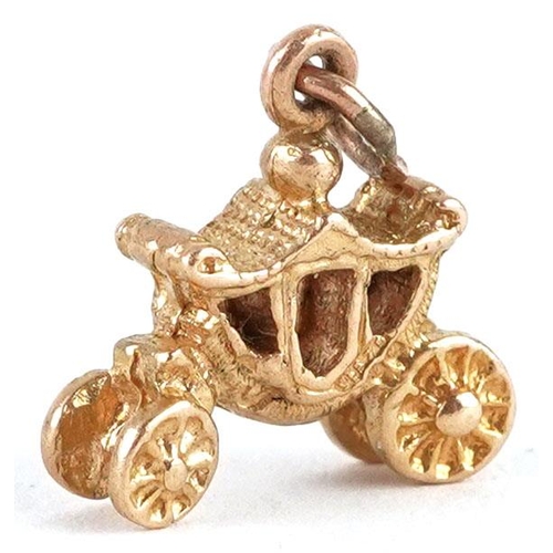 476 - A 9ct gold charm in the form the coronation coach, 1.3cm in length, 1.8g.