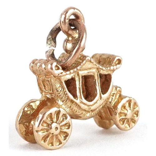 476 - A 9ct gold charm in the form the coronation coach, 1.3cm in length, 1.8g.