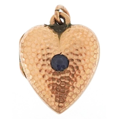 343 - A 9ct gold love heart locket set with a sapphire solitaire, 1.9cm high, 2.9g.