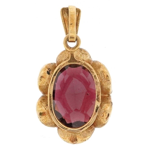 186 - A 9ct gold garnet solitaire pendant with flower head setting, the garnet 11.80mm x 10.0mm x 4.80mm d... 