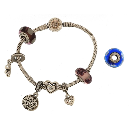 378 - A Pandora silver charm bracelet with seven charms, 17cm in length, 33.0g, with boxes and gift bag.