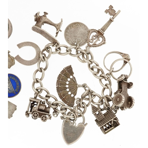 384 - Two silver charm bracelets with a collection of mostly silver charms including a matador, Nefertiti ... 