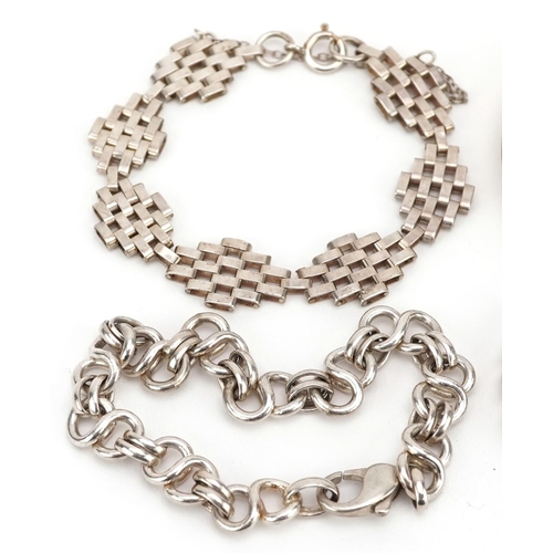 608 - Four silver bracelets including a christening bracelet and a gate bracelet, total 68.4g.