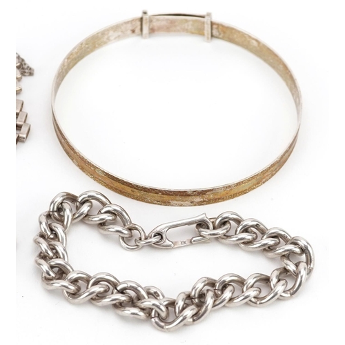 608 - Four silver bracelets including a christening bracelet and a gate bracelet, total 68.4g.