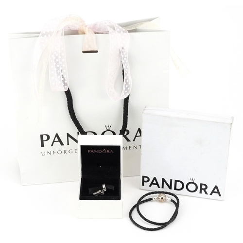 427 - A Pandora silver and cord double charm bracelet and a charm in the form of a trainer set with clear ... 