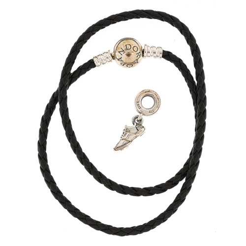 427 - A Pandora silver and cord double charm bracelet and a charm in the form of a trainer set with clear ... 