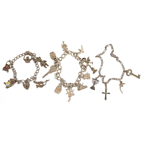 402 - Three silver charm bracelets with a collection of mostly silver charms, total 58.8g.