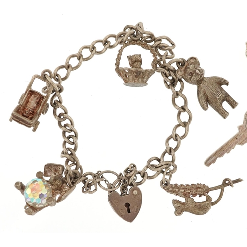 402 - Three silver charm bracelets with a collection of mostly silver charms, total 58.8g.