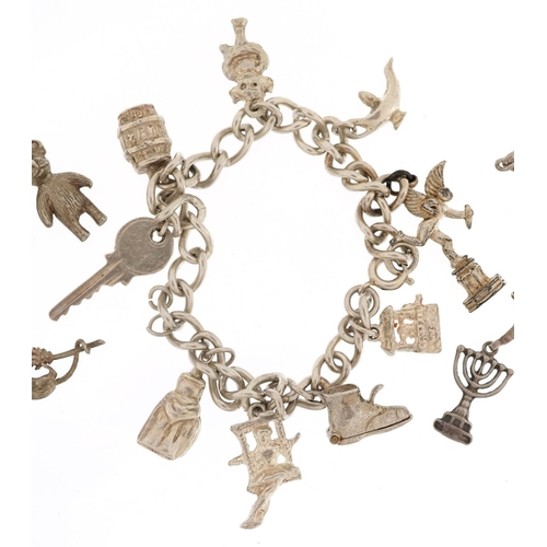 402 - Three silver charm bracelets with a collection of mostly silver charms, total 58.8g.