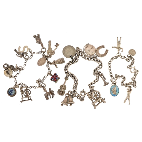 283 - Three silver charm bracelets with a collection of mostly silver charms including spinning wheels, en... 