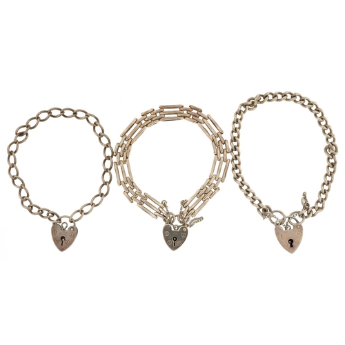 392 - Three silver bracelets with love heart padlock clasps, total 34.5g.