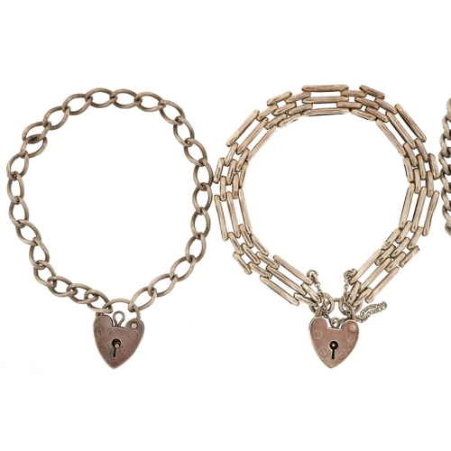 392 - Three silver bracelets with love heart padlock clasps, total 34.5g.